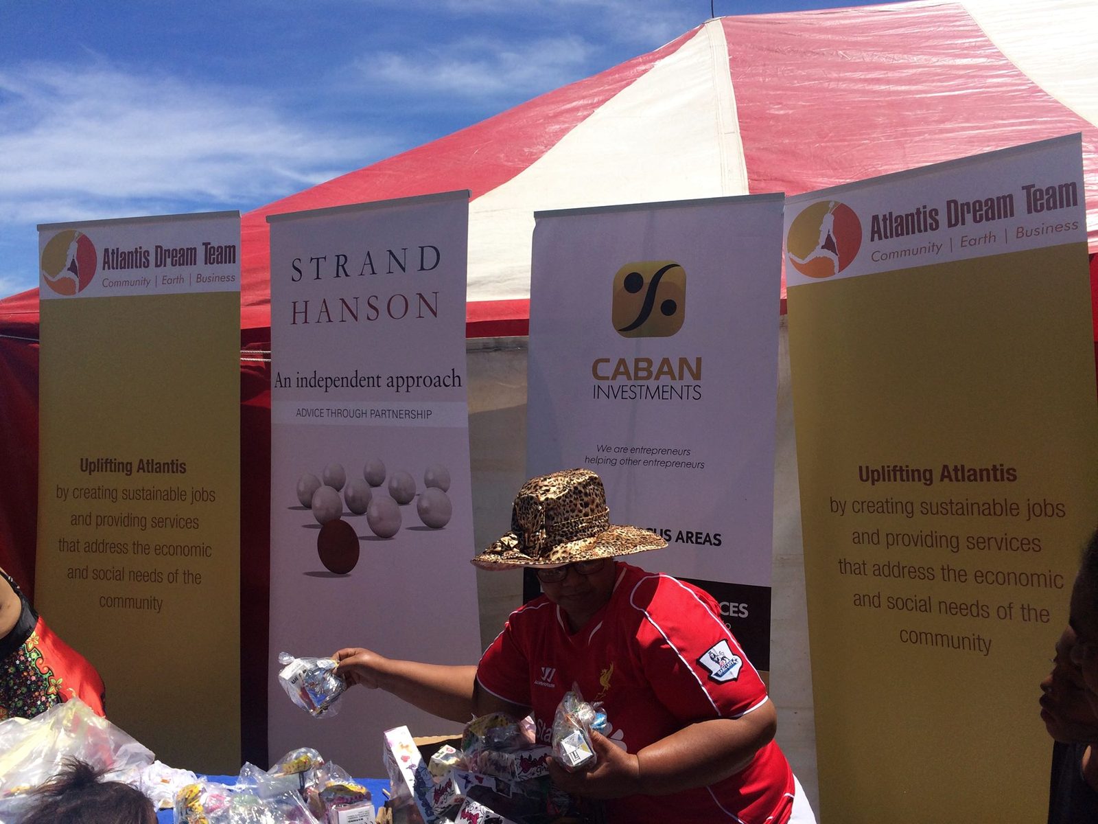 Atlantis Dream Team, Strand Hanson, and Caban banners together at a community event